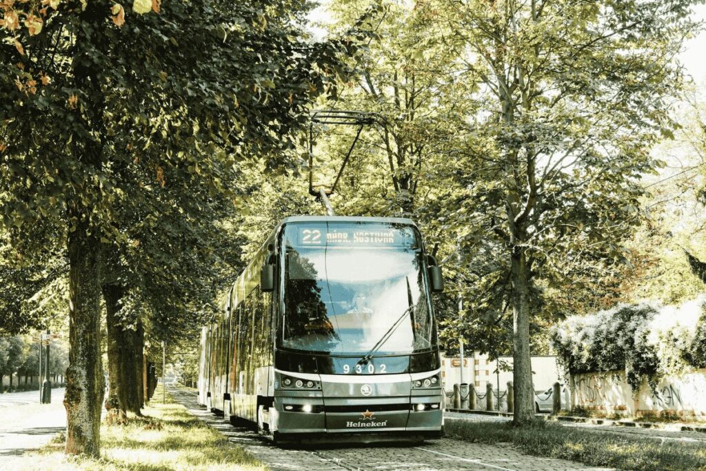 Prague Tram 22 traveling through a tree-lined street on its route toward Prague Castle