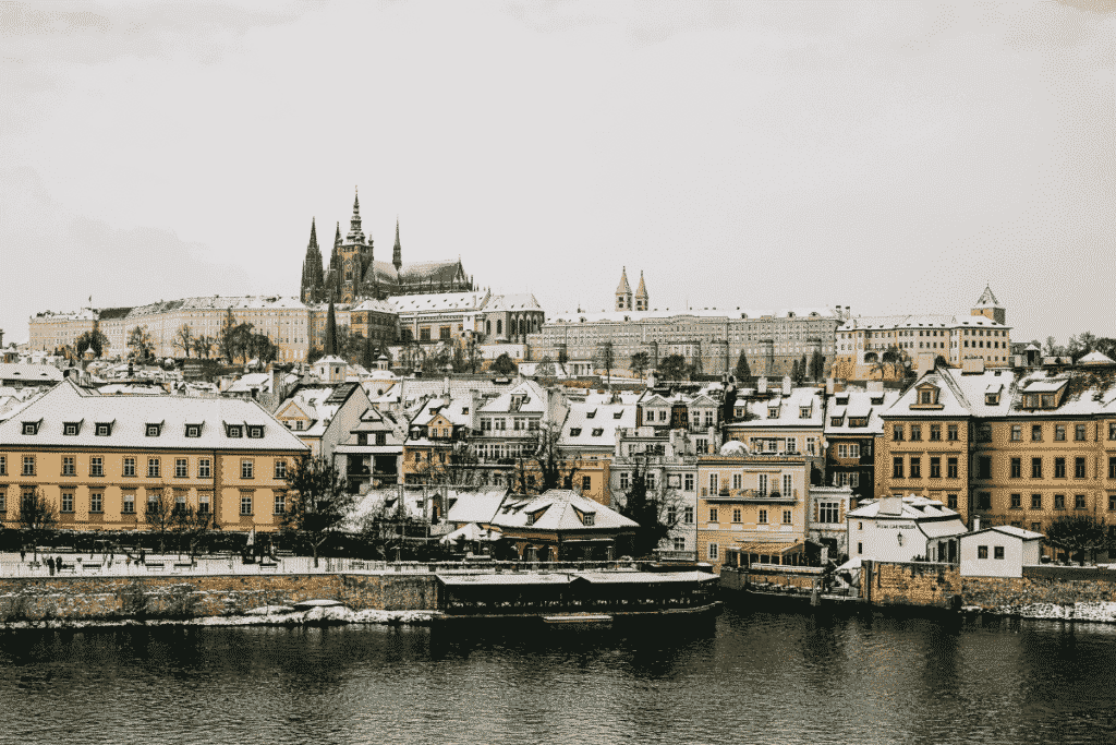 Prague in winter with snow-covered rooftops — low season for cheap hotels in Prague
