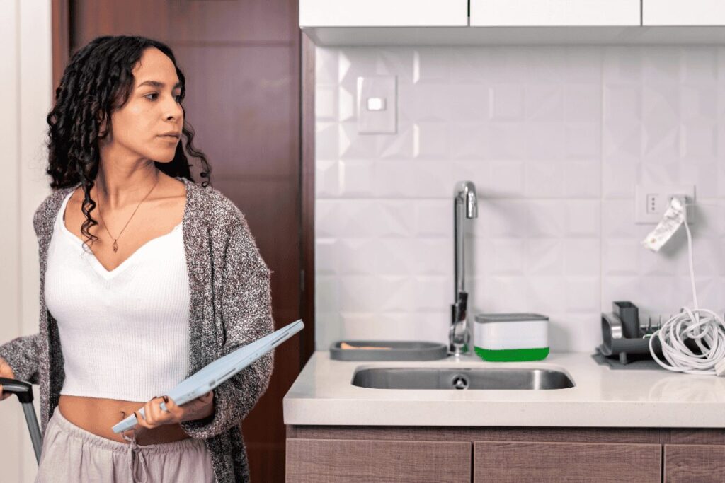 Aparthotel kitchenette and traveler with luggage in Prague