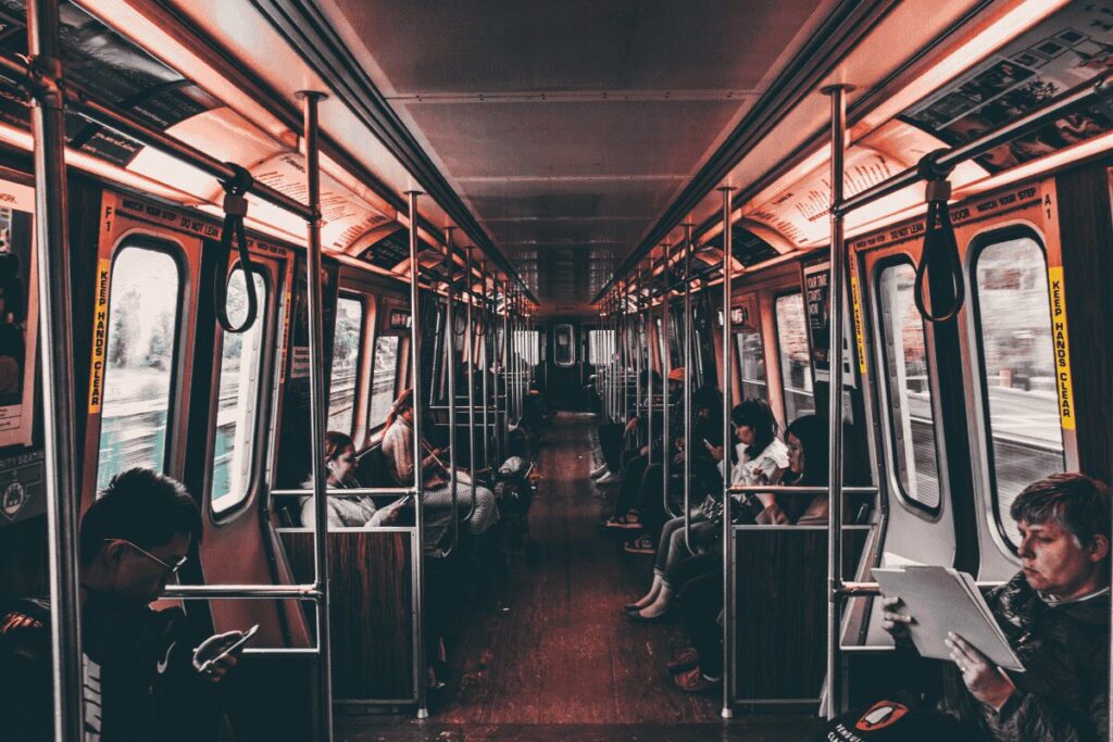 Passengers riding Prague public transport inside a metro carriage