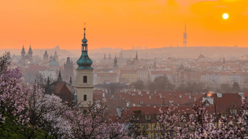 Skyline of Prague with historic buildings and church towers.