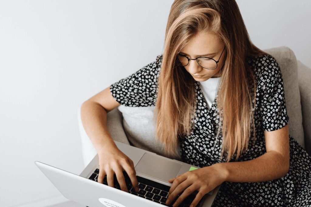 Student working on laptop while tracking Czech student visa application