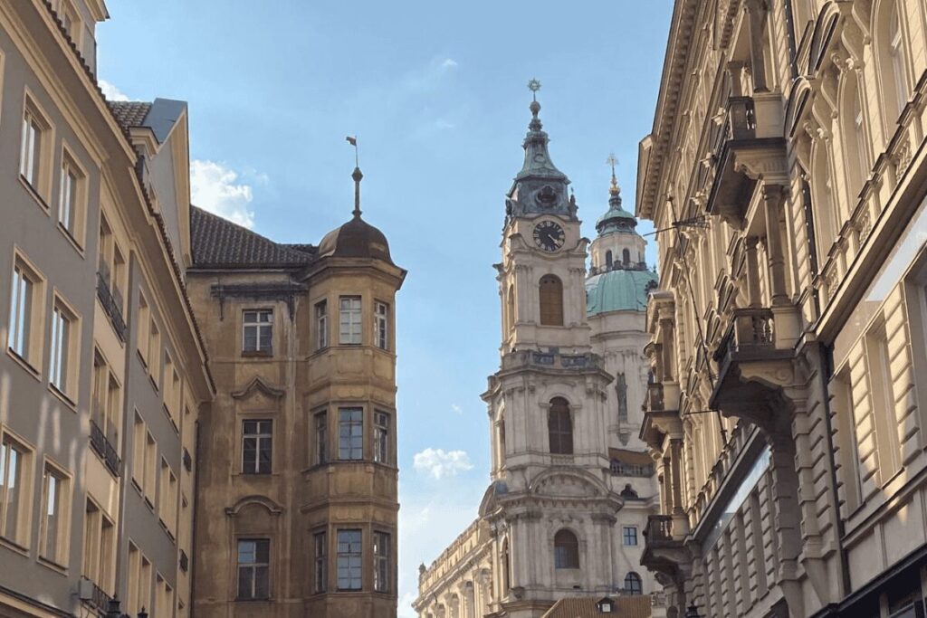 Historic Prague street view with Baroque church towers and classic architecture