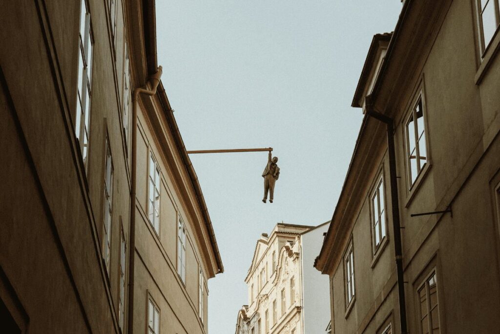 Sigmund Freud hanging sculpture by David Černý suspended above Husova Street in Prague
