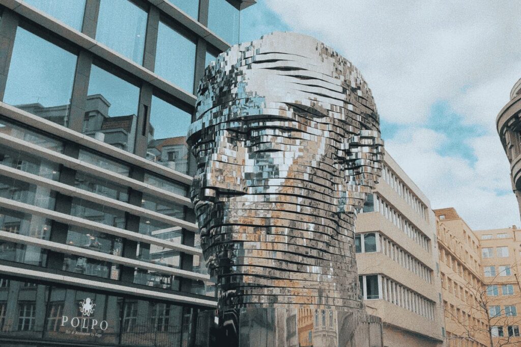 Rotating stainless steel Franz Kafka head sculpture outside Quadrio shopping center in Prague