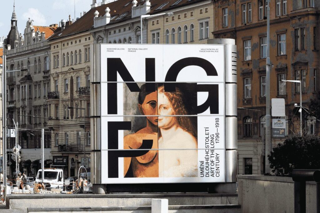 National Gallery Prague exhibition sign in front of historic buildings in Prague