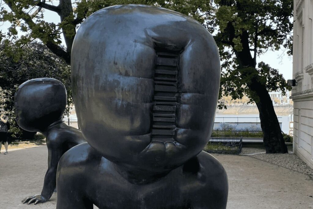 Close-up of David Černý’s faceless baby sculpture in Kampa Park in Prague