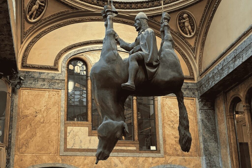 Saint Wenceslas riding an upside-down horse sculpture inside Lucerna Passage in Prague
