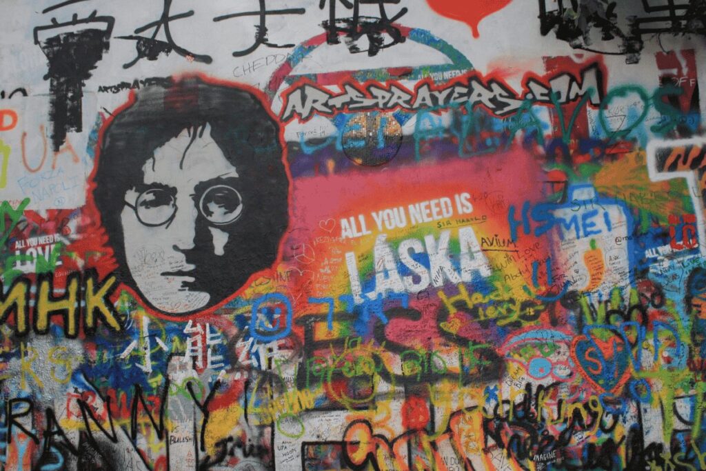 Colorful graffiti and John Lennon portrait at the famous Lennon Wall in Prague