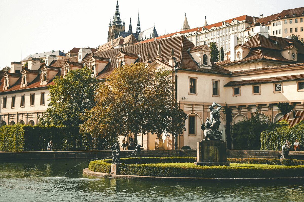 View of Waldstein Garden in Prague with a pond, statues, and historic buildings surrounding the Baroque garden.