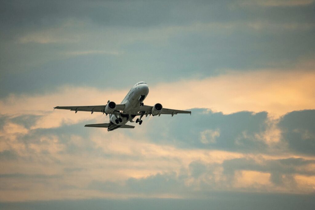 Plane taking off from Airport at sunset