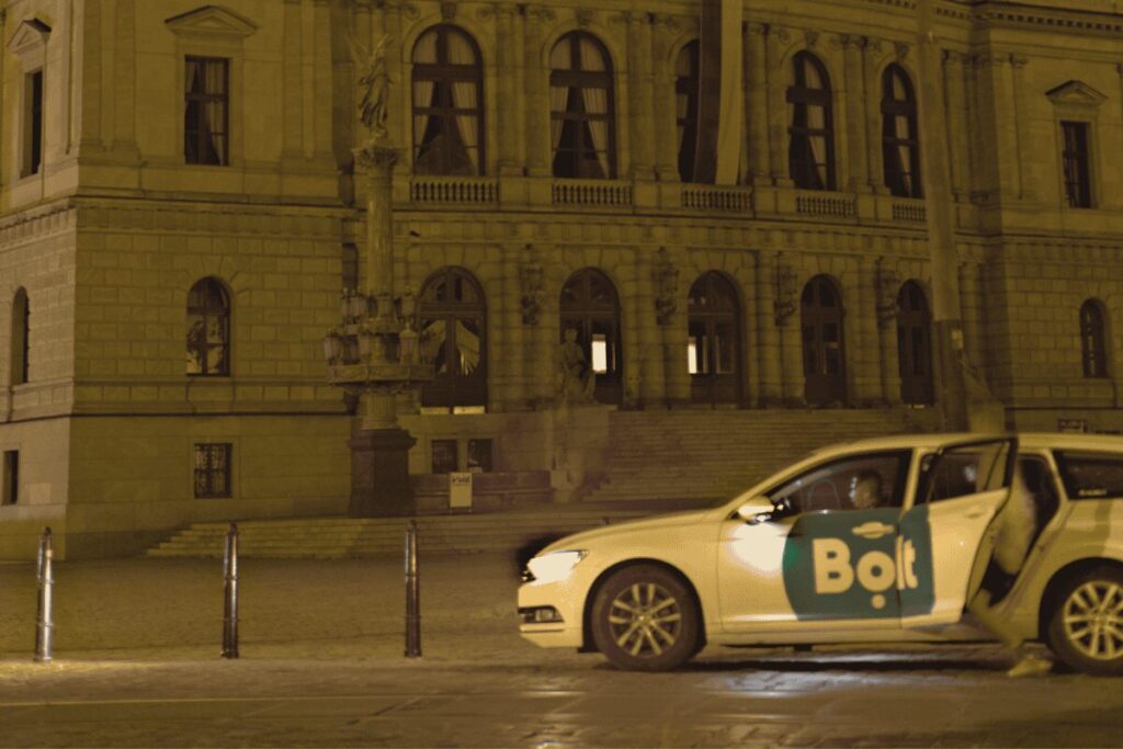 Bolt ride-share car parked outside a historic Prague building at night