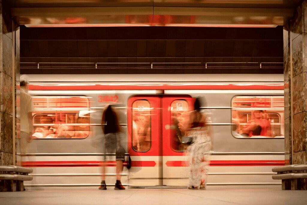 Passengers boarding a red Prague metro train