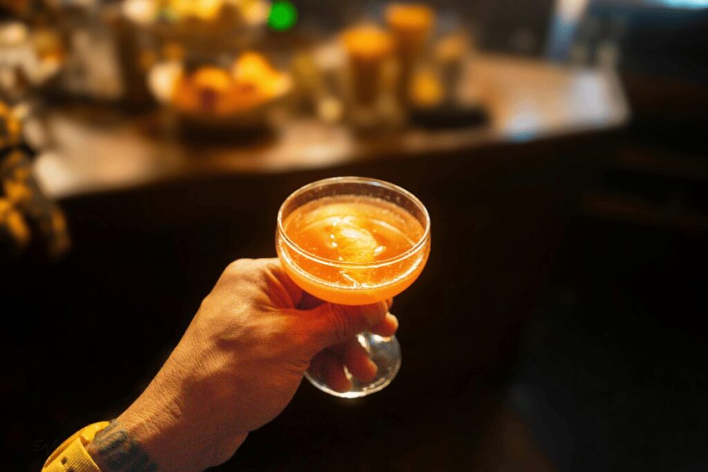 Orange cocktail in coupe glass
