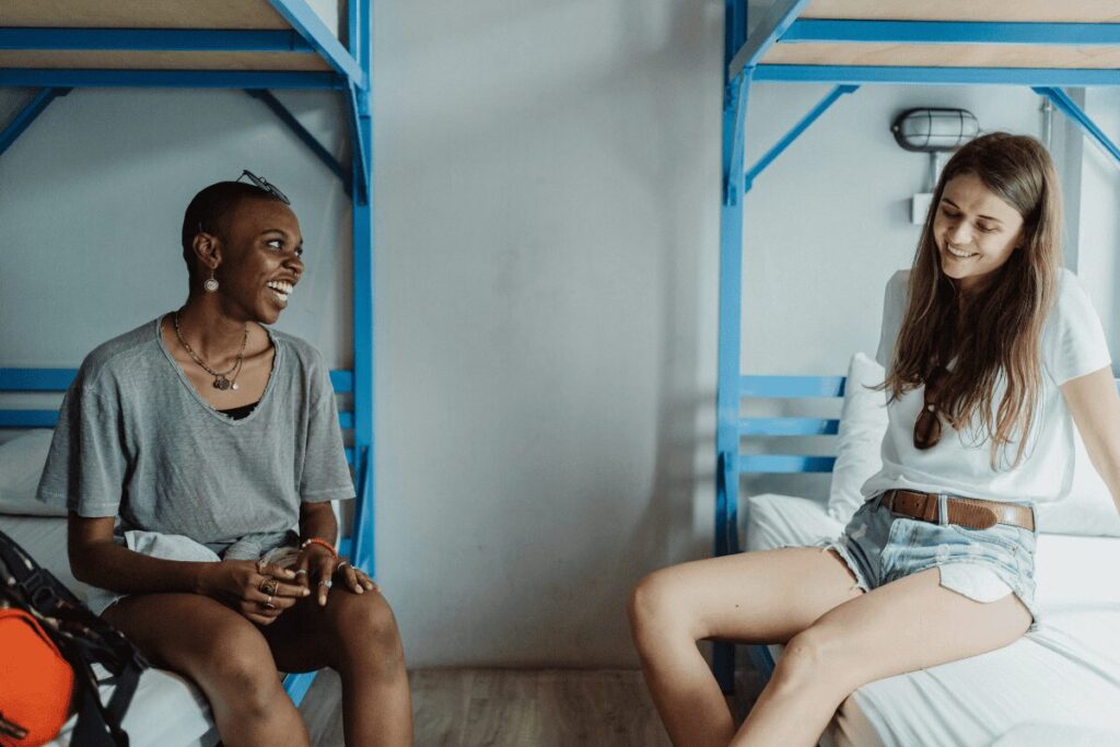 Women travelers chatting in a female dorm room