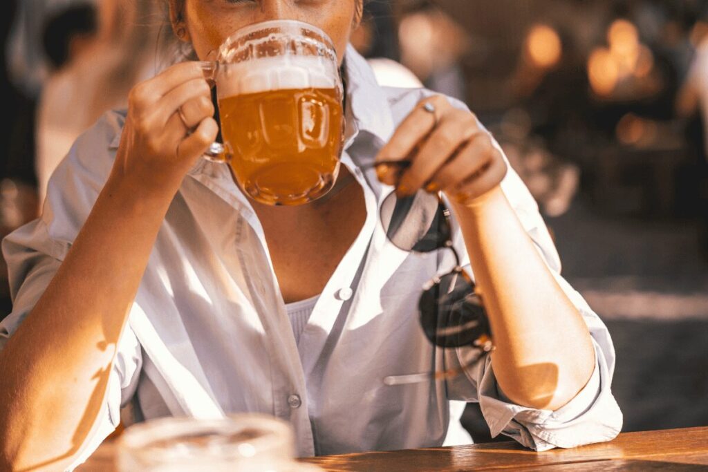 Woman drinking beer in Karlín